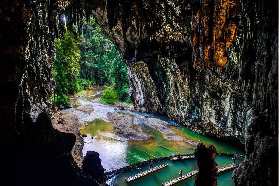 Lantern-lit chambers of Tham Lod river cave near Soppong
